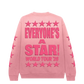 Pink sweatshirt with 'Everyone's a Star! World Tour '26' text and star designs on a white background