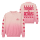 A pink crewneck sweatshirt with a vertical gradient fading from light pink at the top to a deeper pink at the bottom. The back of the sweatshirt features a large pink graphic reading 'EVERYONE'S A STAR! WORLD TOUR '26' surrounded by stars, and the sleeves have pink stars printed down the sides.
