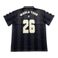 Back view of a black vertically striped 5 seconds of summer soccer jersey with 'WORLD TOUR' and the number '26' printed in cream on the back, featuring cream stars on the sleeves.
